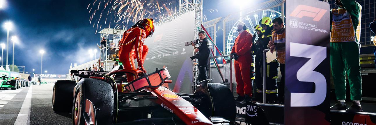Carlos Sainz getting out of his Ferrari F1 car after finishing third in the 2023 Bahrain Grand Prix