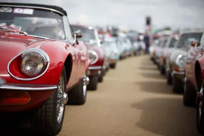 Jaguar E-types lined up in the paddock at The Classic waiting to go out and parade around the Silverstone Circuit