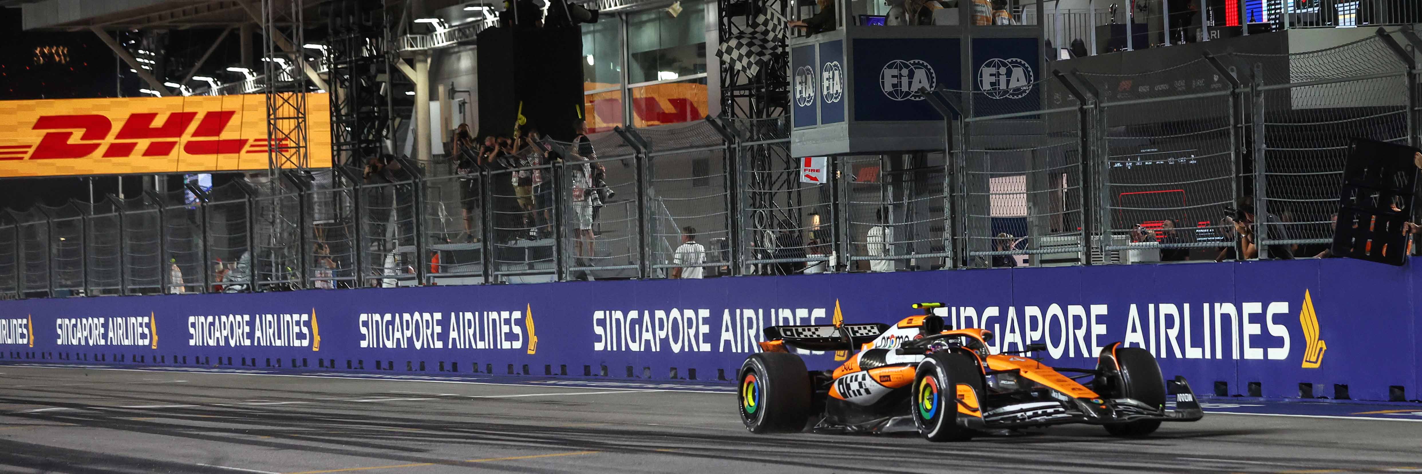 Lando Norris crosses the line in Singapore