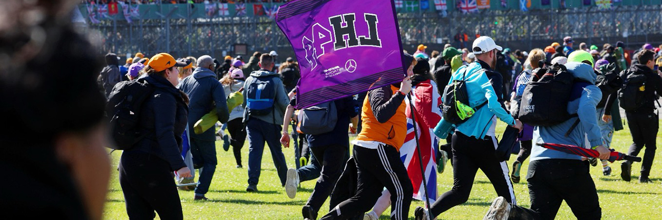 A Silverstone fan waving a Lewis Hamilton flag after the race