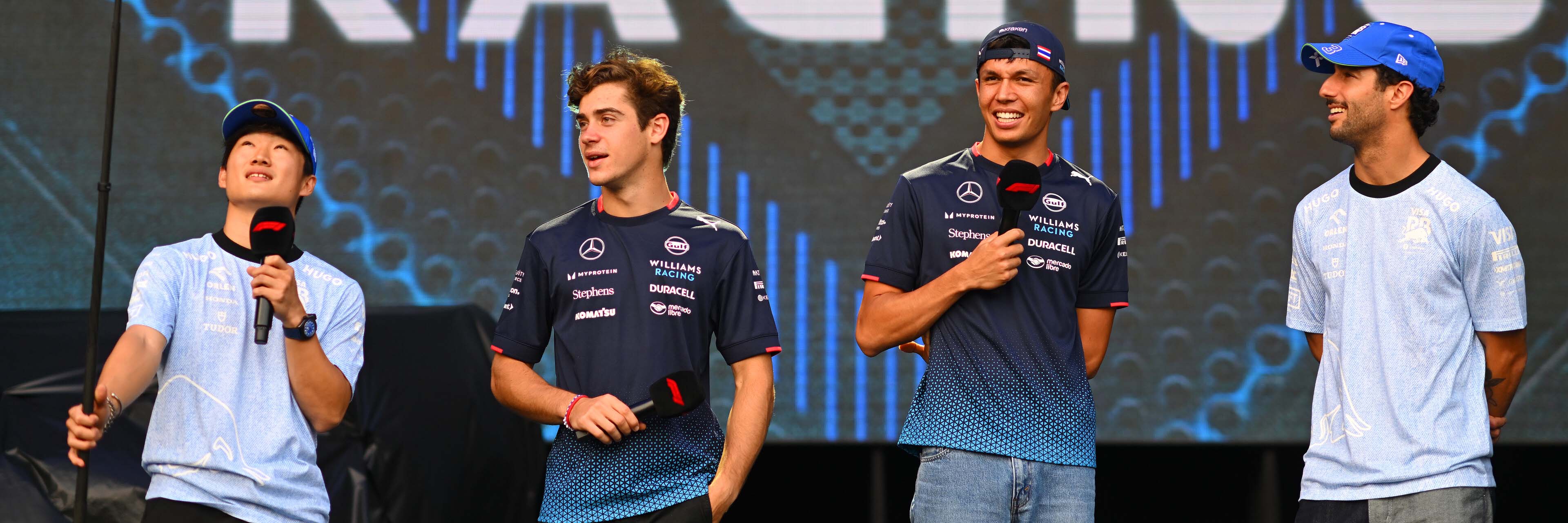 Yuki Tsunoda, Franco Colapinto, Alex Albon and Daniel Ricciardo doing interviews on stage