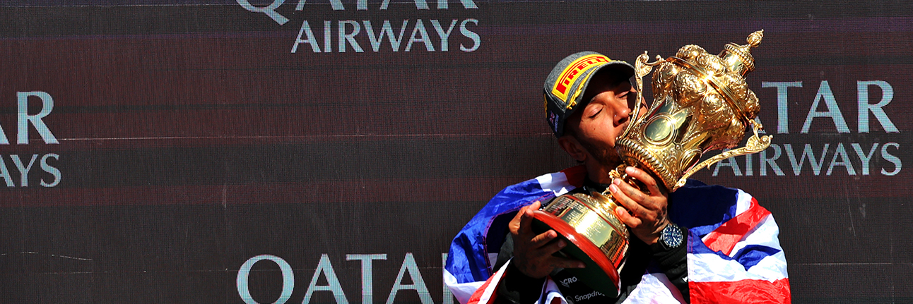 Lewis Hamilton kissing the Silverstone trophy