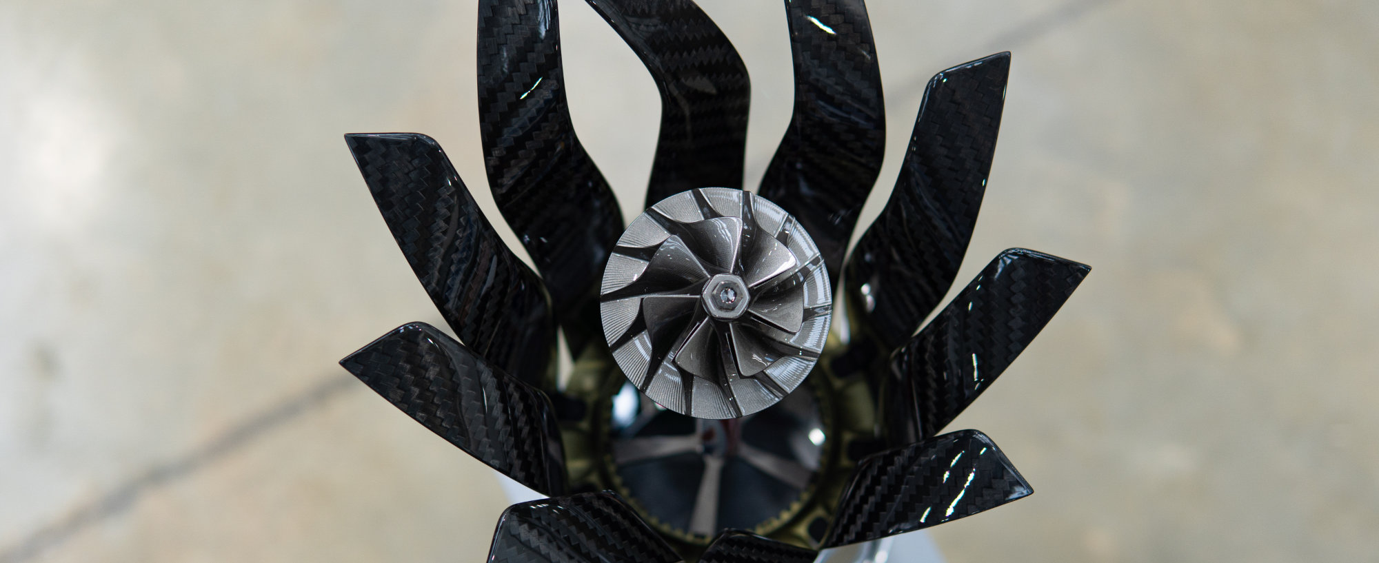 The turbocharger impeller within the Constructors’ trophy, in graphite colour. The first place trophy has a gold colour, second place silver, and third place bronze. 