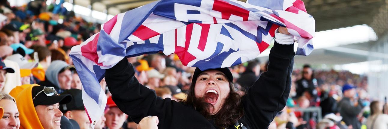 A British fan waving the union jack in the grandstands at Silverstone