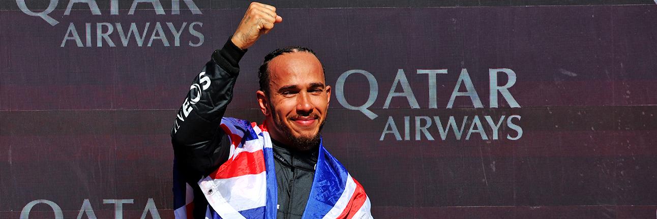 Lewis Hamilton stood on the podium after winning the 2024 British Grand Prix