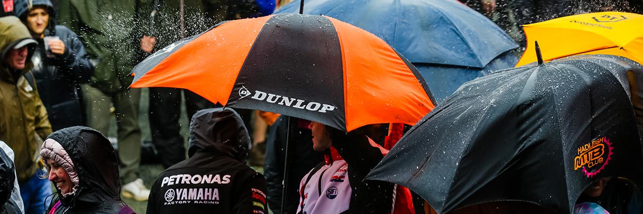 Fans using umbrellas during the MotoGP British Grand Prix