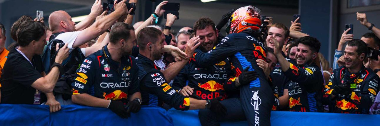 Max Verstappen jumps into his team celebrating his victory in Spain