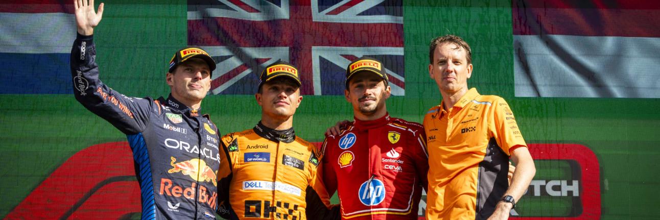 podium at zandvoort. verstappen waving, norris and leclerc middle, norris's engineer on the right