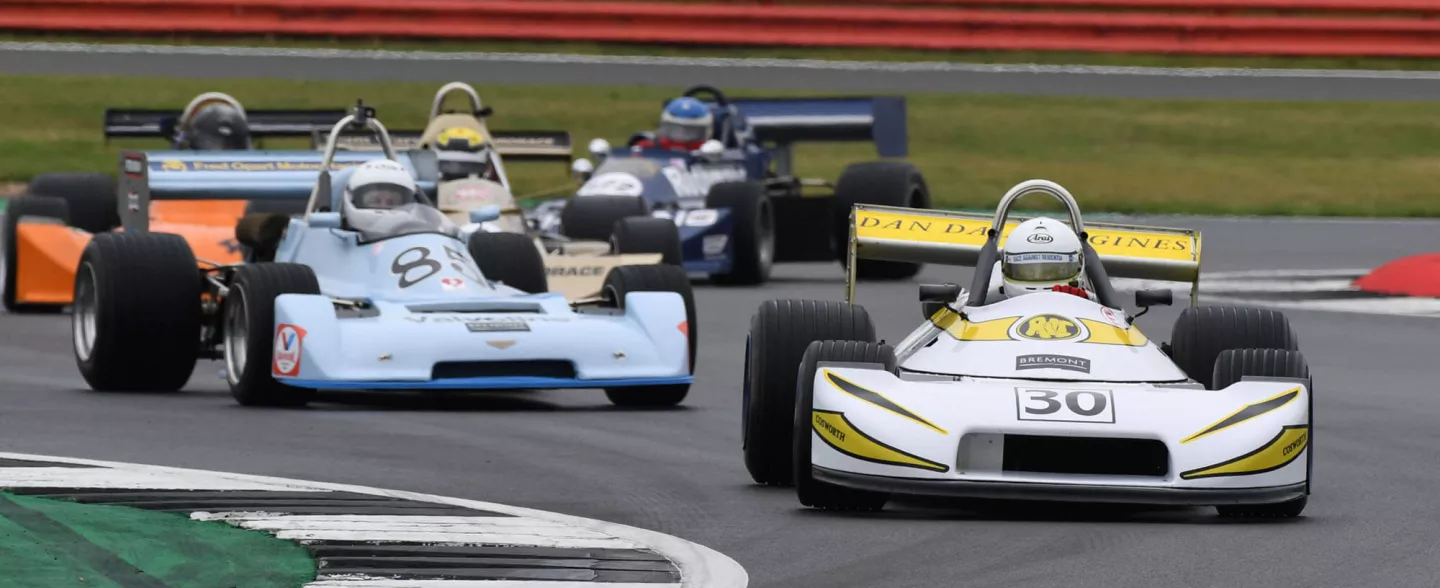 A group of F2 cars competing the HSCC Historic F2 race at The Classic at Silverstone
