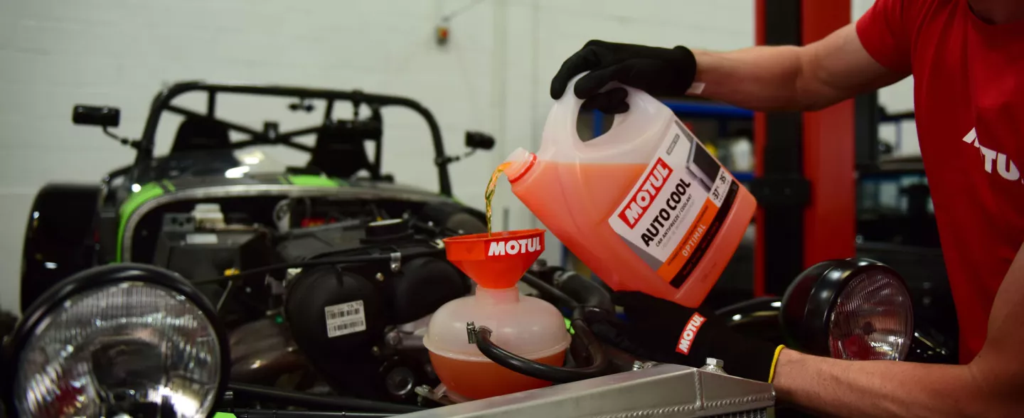 motul product being poured into a car